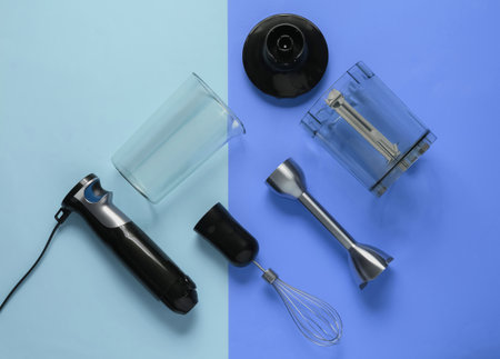 Electric hand mixer. Set of nozzles and containers for blender on blue pastel background. Top view, flat layの写真素材