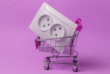 Shopping trolley with double electrical outlet on purple background