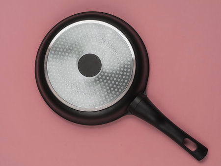 The bottom of the non-stick pan. Inverted empty pan upside down on pink background. Top viewの写真素材