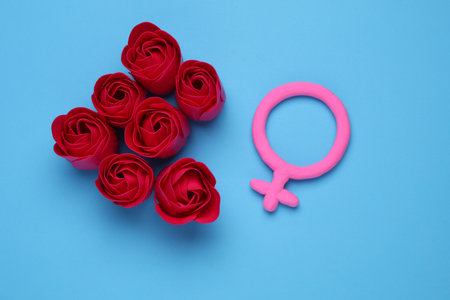 Rose buds with female gender symbol on blue backgroundの写真素材