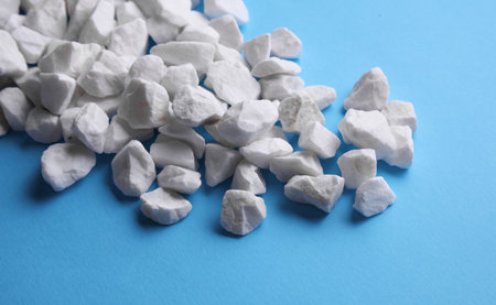 White pebbles on a blue background.の写真素材