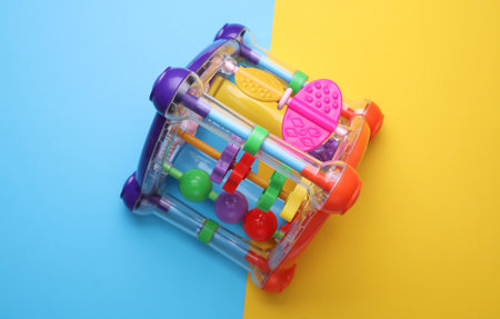 Colorful toys on a blue and yellow background. Top view.