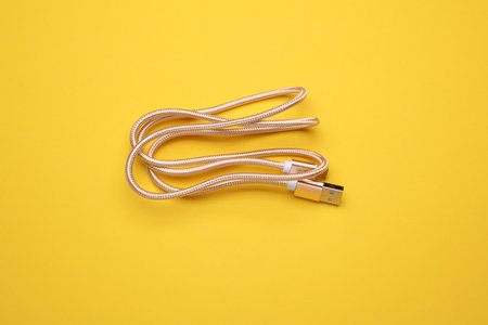 USB type C cable isolated on yellow background