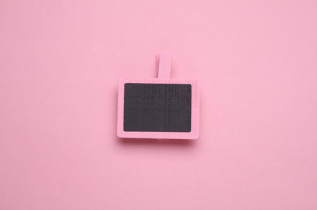 Chalkboard for notes on clothespin, pink backgroundの写真素材