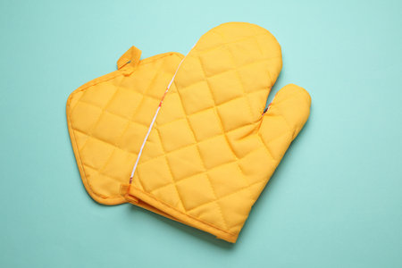 Kitchen glove for baking on blue backgroundの写真素材