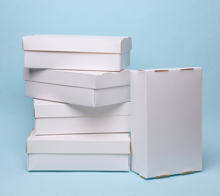 Stack of White cardboard boxes on a blue background