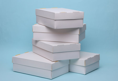 Stack of White cardboard boxes on a blue background