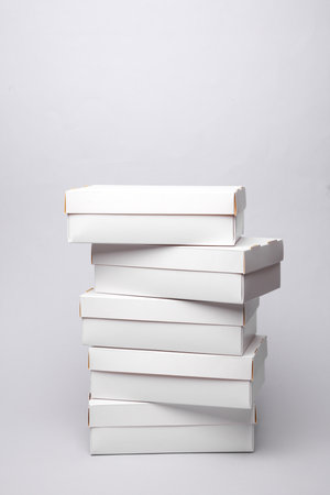 Stack of White cardboard boxes on a gray background