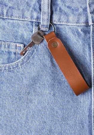 Leather keychain with key in jeans pocketの写真素材