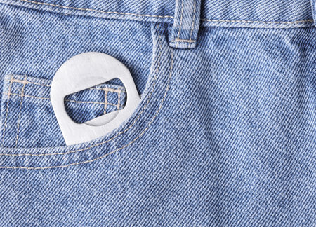 Beer opener in the pocket of blue jeans