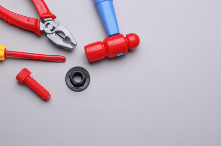Set of children's toy tools on a gray background