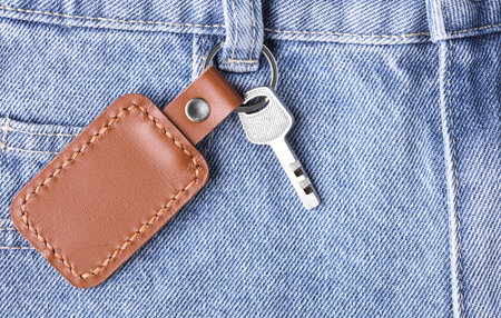 Leather keychain with key hangs on jeansの写真素材