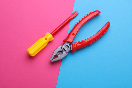 Set of children's toy tools on a pink blue background. Flat layの写真素材