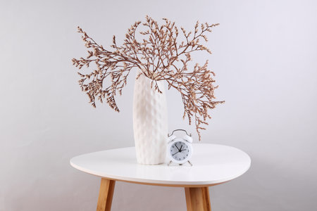 Vase with dried flowers on a coffee tableの写真素材