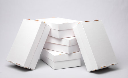 Stack of White cardboard boxes on a gray background