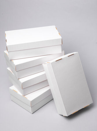 Stack of White cardboard boxes on a gray backgroundの写真素材