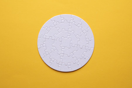 White blank round Jigsaw puzzle on yellow background. Mockup for design