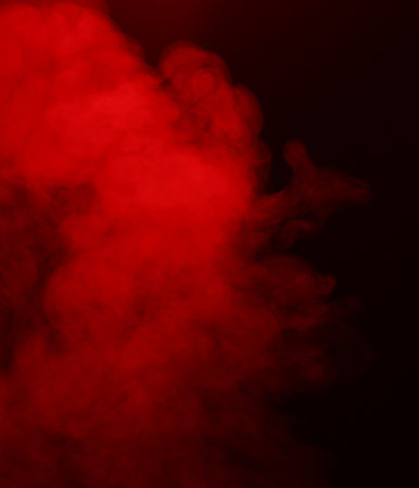 Steam or smoke in red neon light on black background