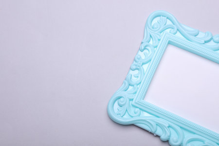 Ornamental empty photo frame on gray background