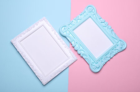 Ornamental blank photo frames on pink blue background