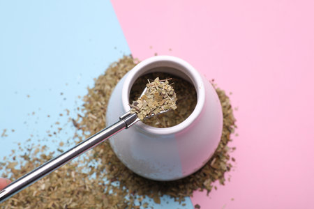 Calabash and bombilla with mate on a blue and pink background