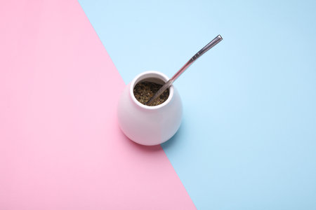 Calabash and bombilla with mate on a blue and pink backgroundの写真素材