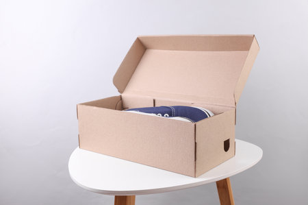 Open Cardboard shoe box on a table