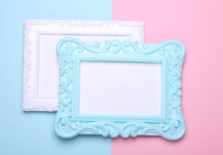 Ornamental blank photo frames on pink blue background