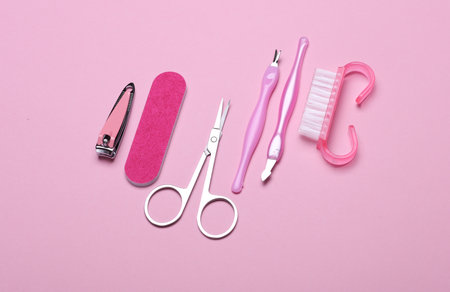 Nail care tools, manicure set on pink background. Flat lay. Top view