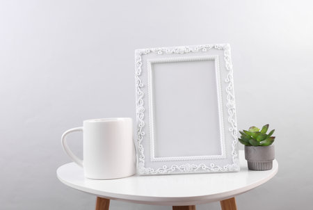 Ornamental empty photo frame on table. Mockup for design