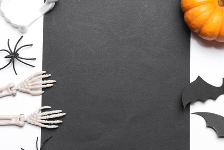 Handmade Halloween decor with card, black paper sheet on white background. Flat layの写真素材