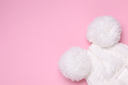 Children's warm hat with balabons on a pink backgroundの写真素材