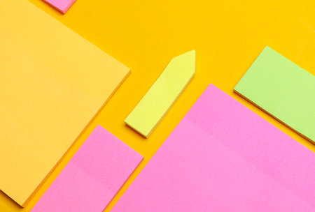 Various blank paper multicolored stickers. Sticky note collection on yellow background