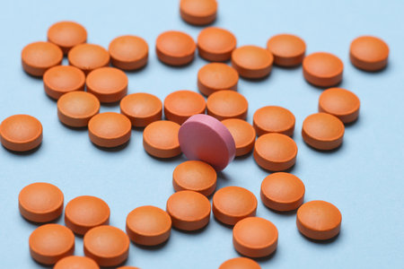 Many Orange pills on a blue backgroundの写真素材
