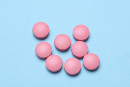 Pink pills on a blue background