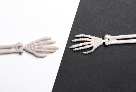 Decorative skeleton hands on white black background.
