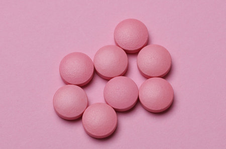 Group of pink pills on pastel backgroundの写真素材