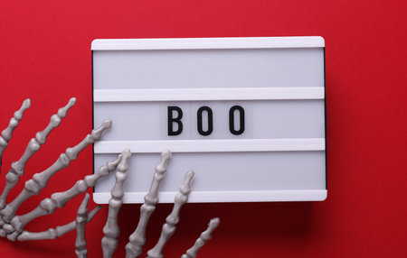 Halloween concept. Lightbox with text BOO and holiday decoration. Flat lay. Top viewの写真素材
