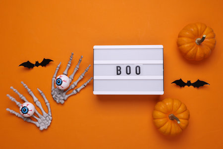 Halloween concept. Lightbox with text BOO and holiday decoration. Flat lay. Top viewの写真素材