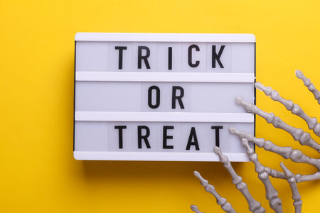 Lightbox with text TRICK OR TREAT and holiday decor. Halloween celebration. Flat layの写真素材