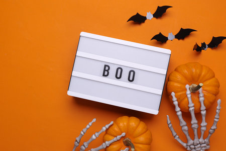 Halloween concept. Lightbox with text BOO and holiday decoration. Flat lay. Top viewの写真素材
