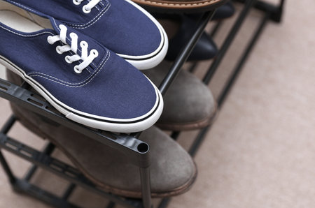 Metal shoe rack with shoes close upの写真素材