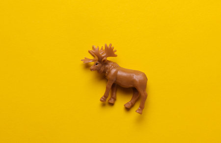 Plastic toy moose figurine on yellow backgroundの写真素材