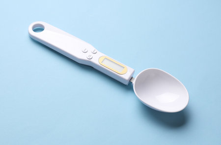 Spoon scales on blue background. Modern gadgetsの写真素材