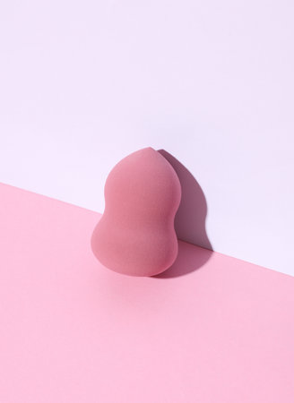 Makeup blender, sponge on white pink background. Creative layout. Minimalism creative beauty still lifeの写真素材
