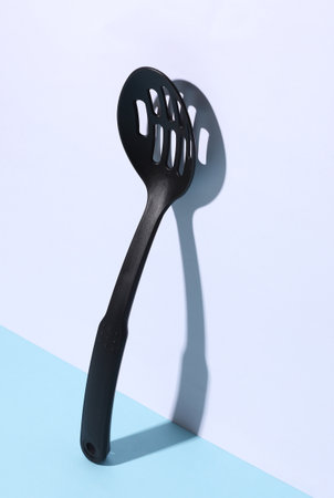 Black kitchen spatula on white blue backgroundの写真素材