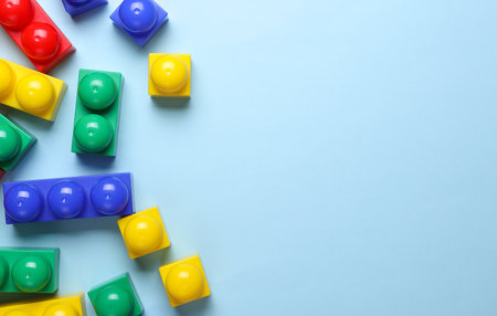 Multicolored plastic cubes of children's construction set on blue backgroundの写真素材
