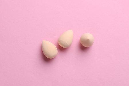 Makeup sponges on pink background. Creative layout. Minimalism creative beauty still lifeの写真素材