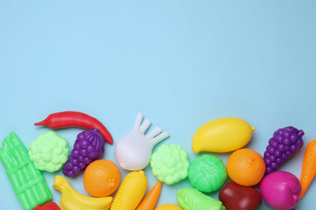 Set of toy plastic vegetables on blue background. Copy spaceの写真素材