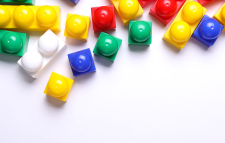 Multicolored plastic cubes of children's construction set on white backgroundの写真素材